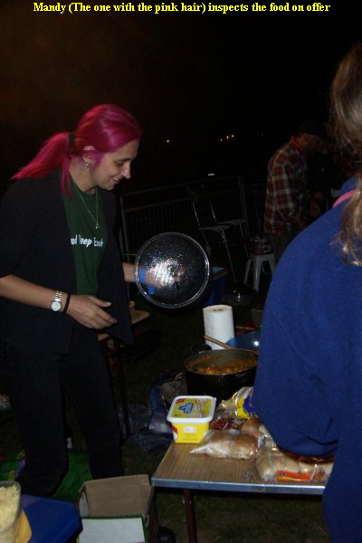 Mandy (The one with the pink hair) inspects the food on offer